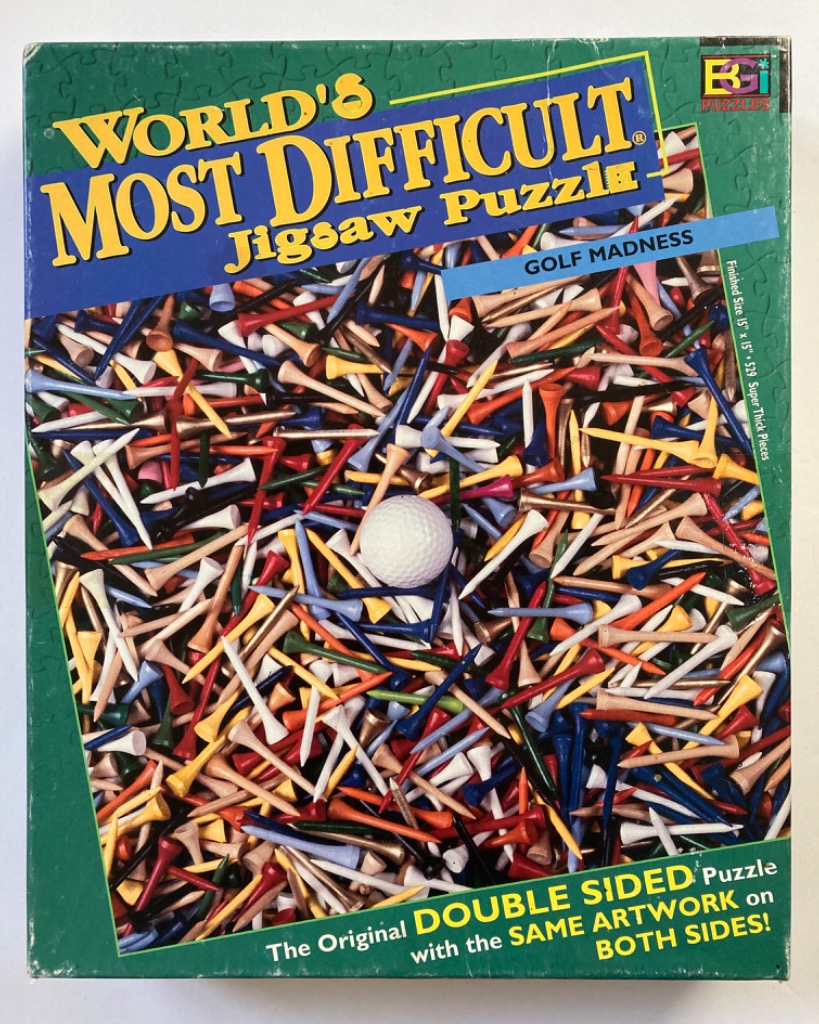 A top-down view of a chaotic pile of colorful golf tees surrounding a single white golf ball.