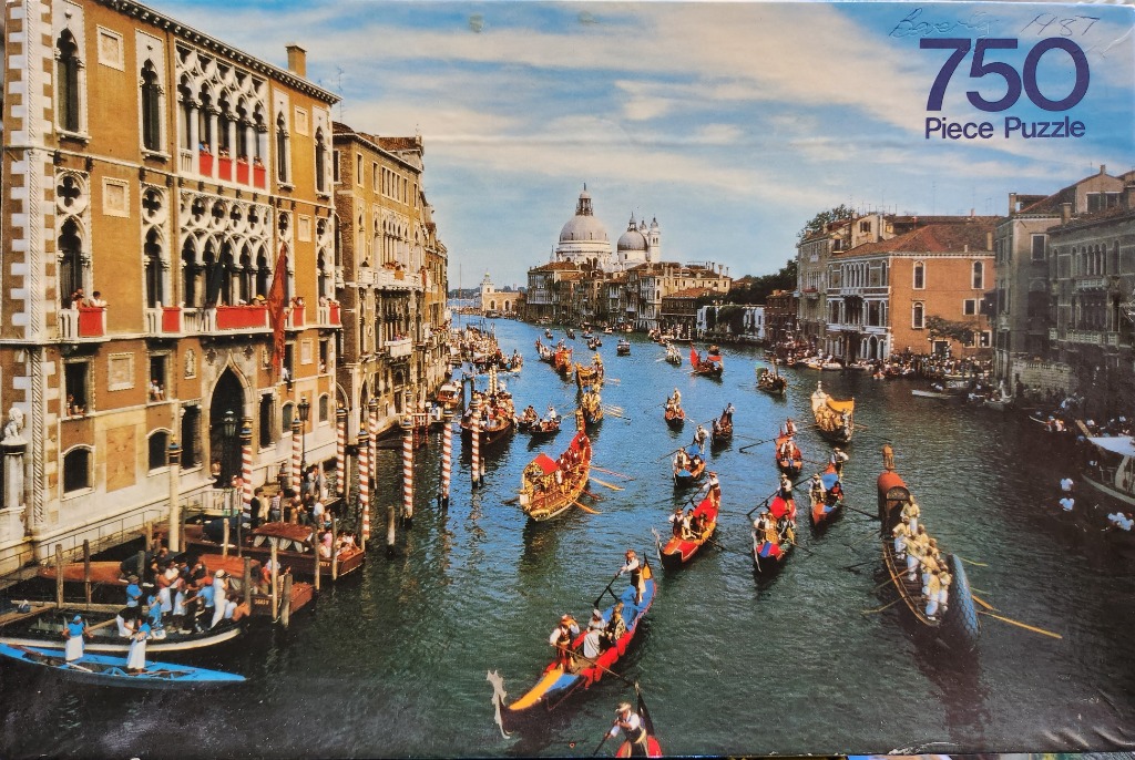 A view of the Grand Canal in Venice featuring historical rowing boats during a regatta.