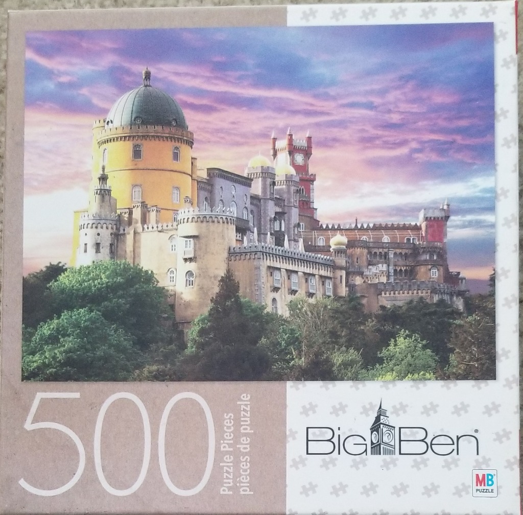 A photograph of the yellow and red Pena Palace in Sintra, Portugal, set against a vibrant purple and orange sunset.
