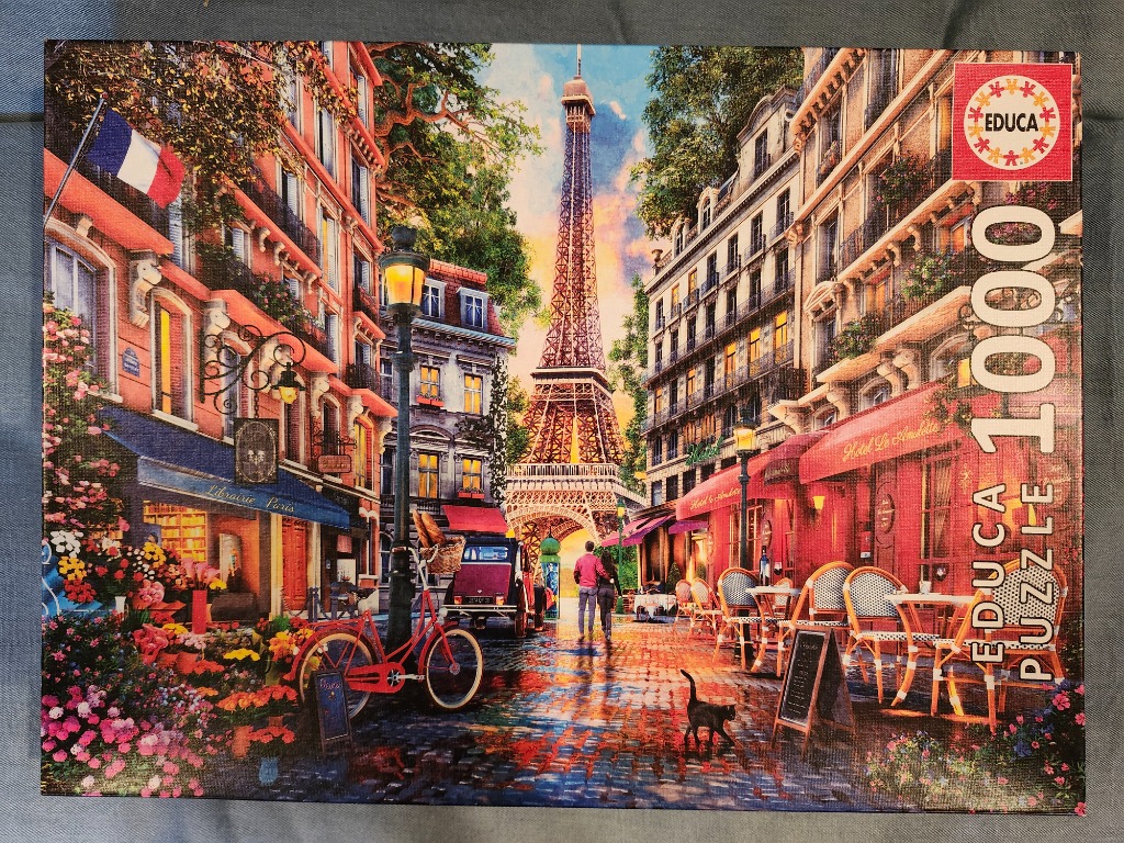 A romantic Paris street scene featuring the Eiffel Tower at sunset with a red bicycle in the foreground.