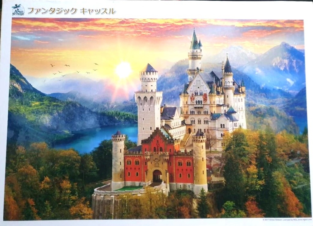 A fairytale castle nestled in autumn mountains at sunset.