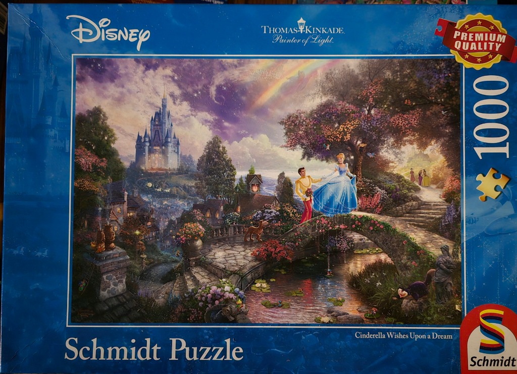 Cinderella and Prince Charming dancing on a stone bridge with a fairy tale castle in the distance under a rainbow.