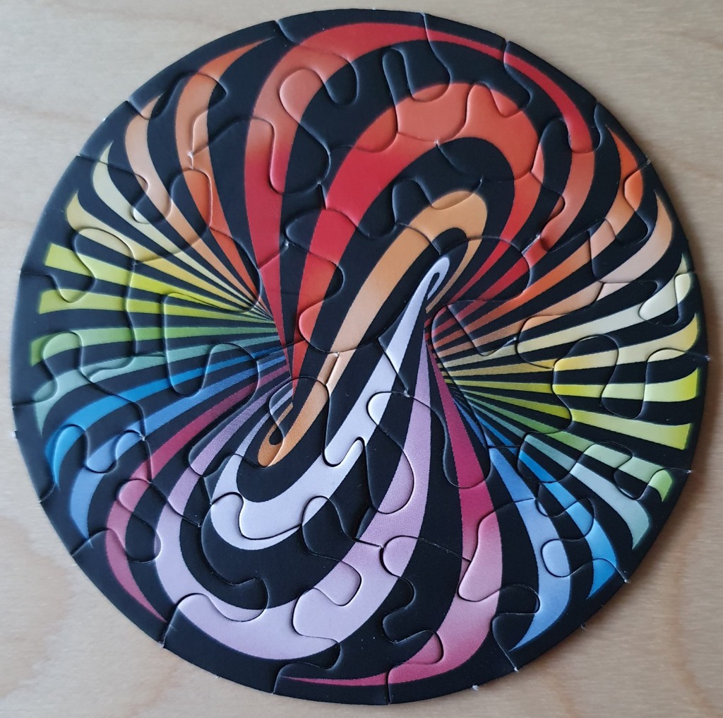 A circular abstract image featuring a psychedelic, swirling design with vibrant rainbow gradients and bold black curves.