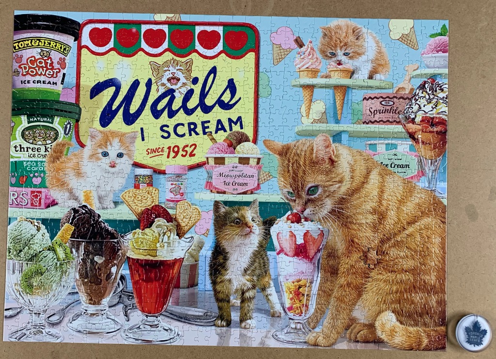 A whimsical illustration of various kittens enjoying ice cream treats in a retro-style shop setting.