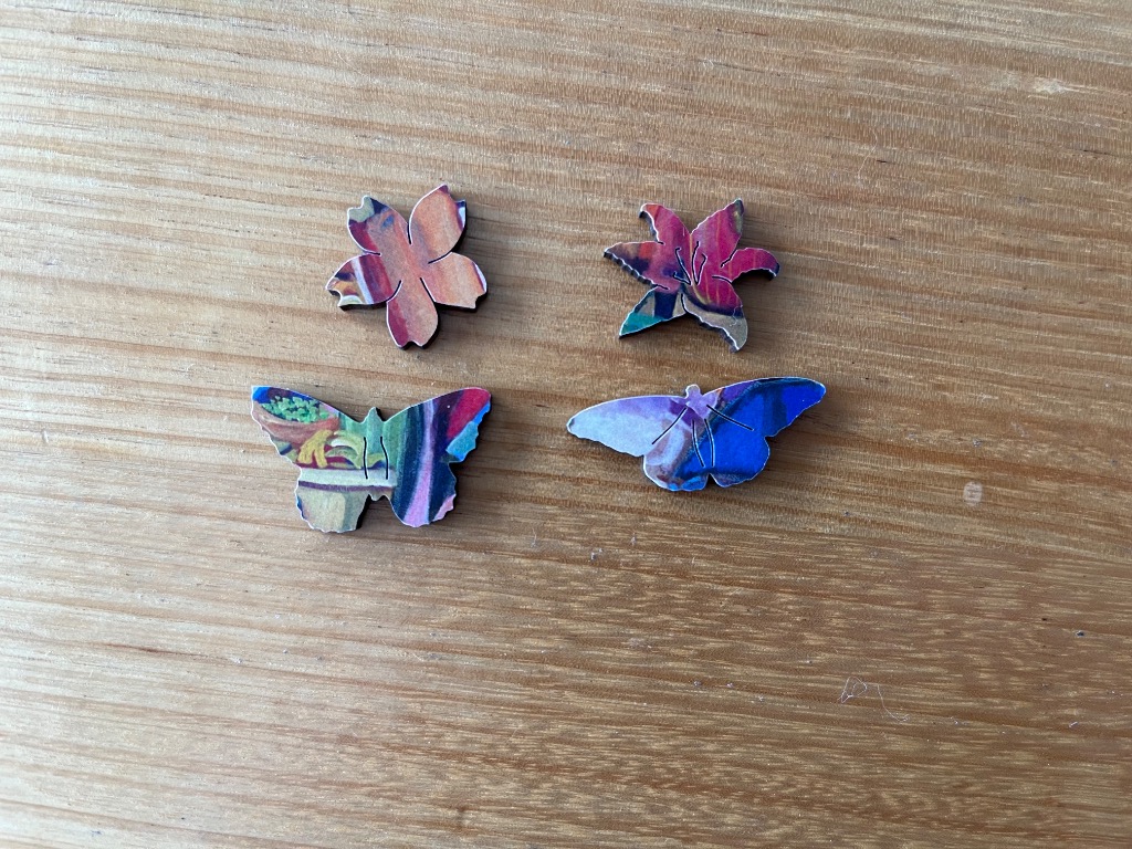 Two small floral-shaped and two butterfly-shaped cutouts with colourful abstract patterns.