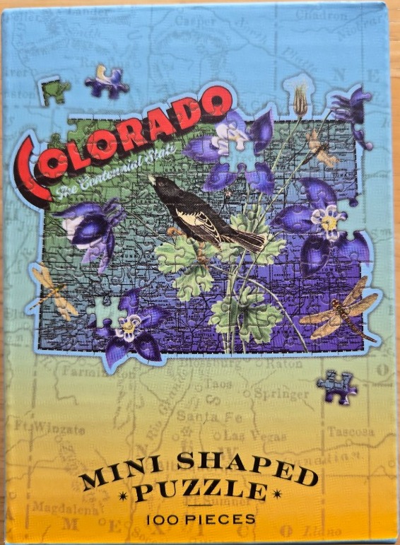 Illustration of the state of Colorado featuring a bird, columbine flowers, and dragonflies against a map background.