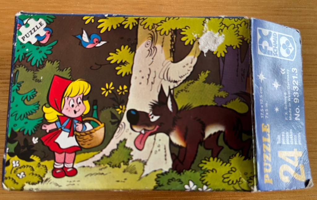 Cartoon illustration of Little Red Riding Hood and the Big Bad Wolf in a forest.