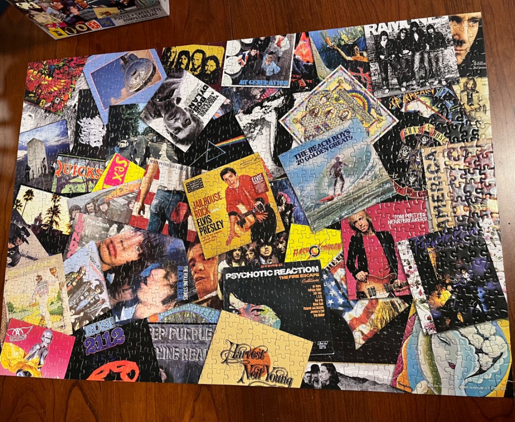 A collage of classic rock and roll album covers arranged in a layered, overlapping composition.