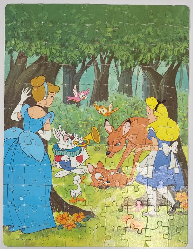 A cartoon forest scene featuring Cinderella, Alice, the White Rabbit, and Bambi characters.