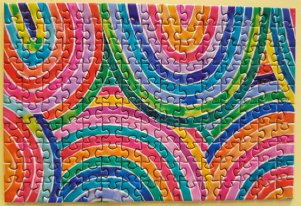 An abstract pattern of overlapping colorful concentric circles and curved bands.