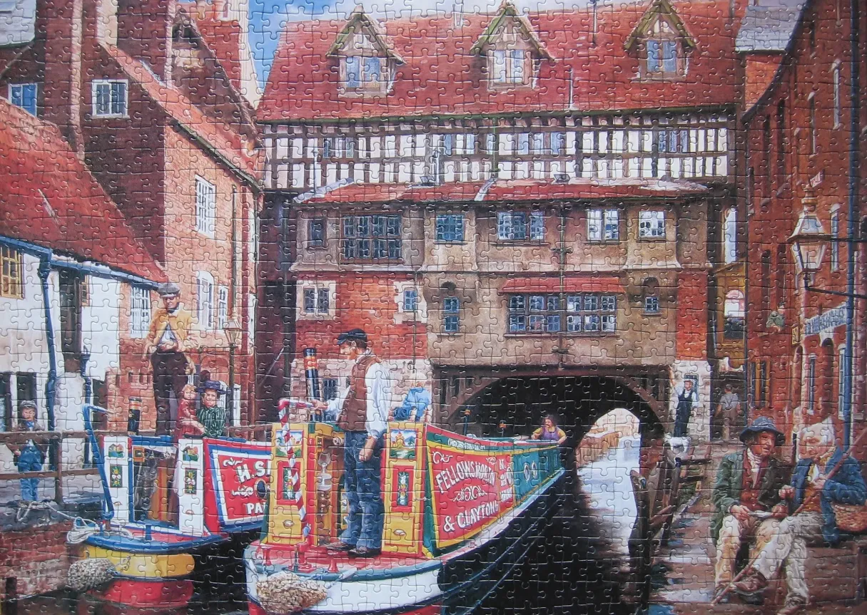 A nostalgic painting of canal boats in an English town with timber-framed buildings and a stone archway.