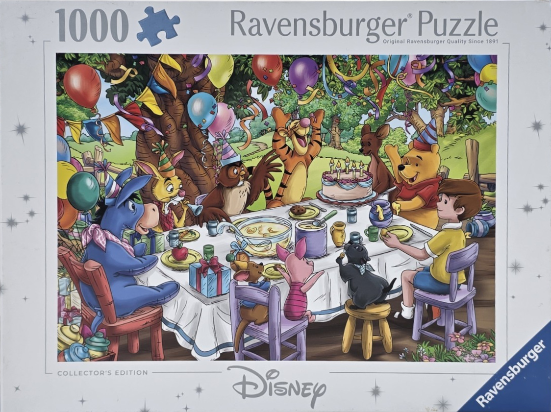 Winnie the Pooh and friends celebrating a birthday party with cake and decorations outdoors.