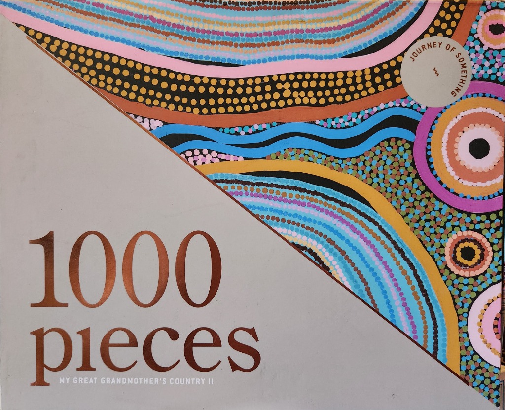 A diagonal composition featuring indigenous-style dot art in vibrant colors on one side and plain grey on the other.