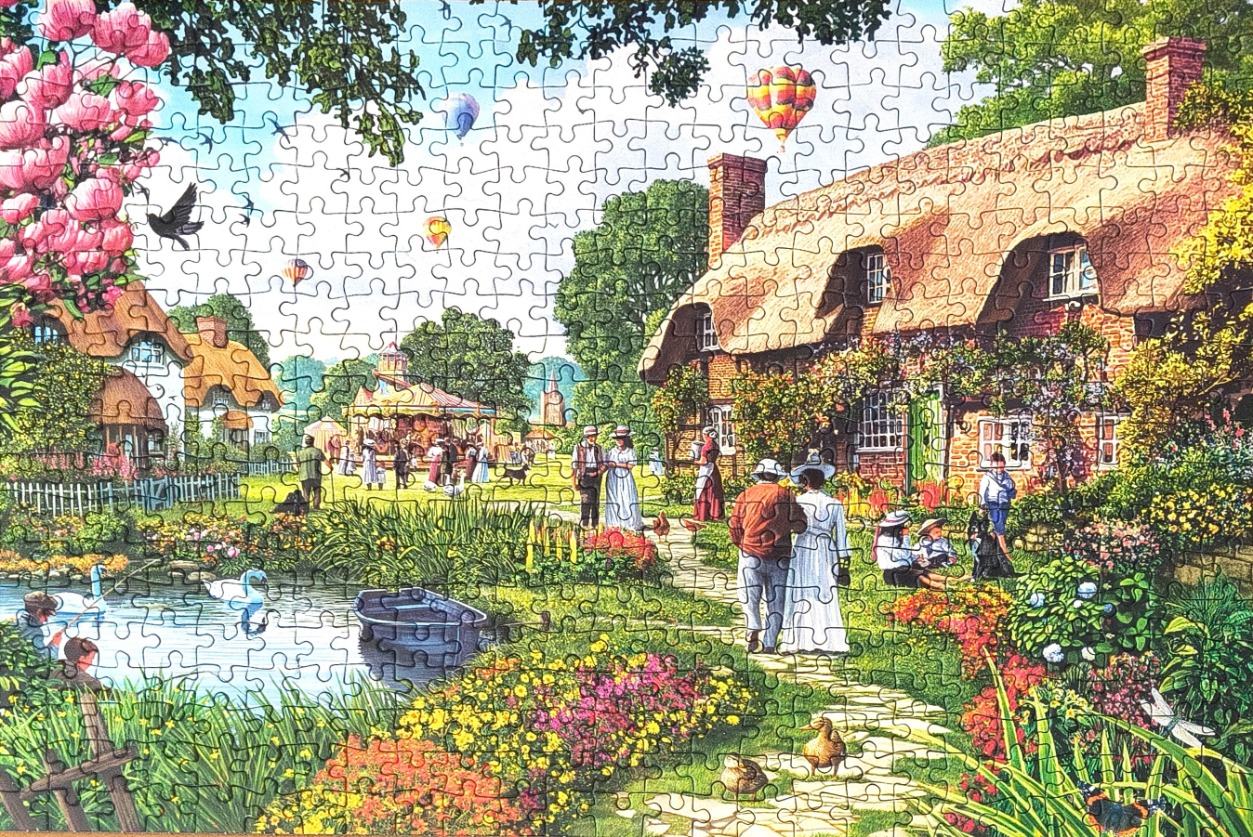An illustration of a charming English village scene with thatched cottages, a garden, and hot air balloons.