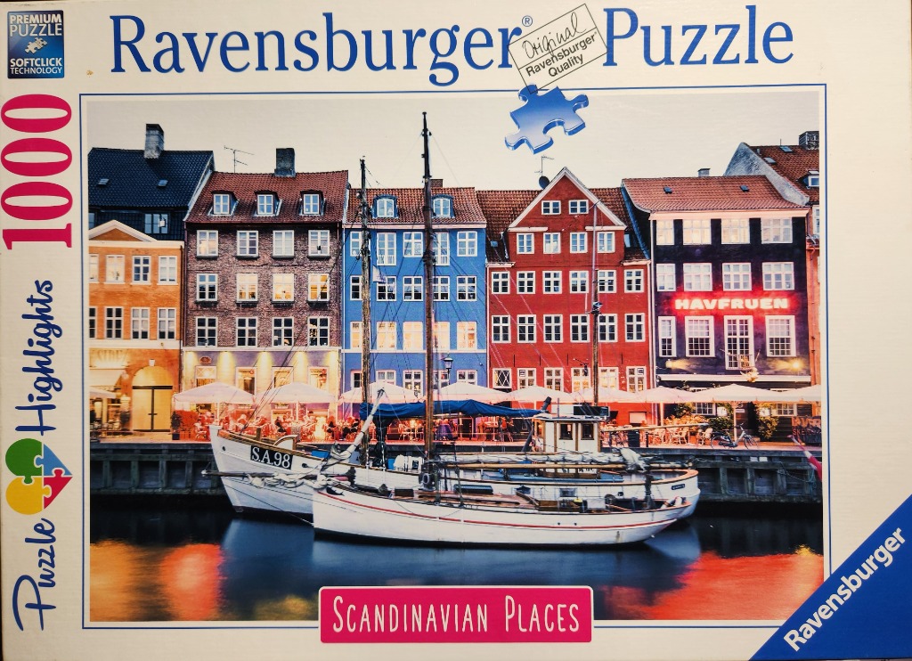 Traditional Nyhavn canal scene in Copenhagen with colorful buildings and docked wooden boats