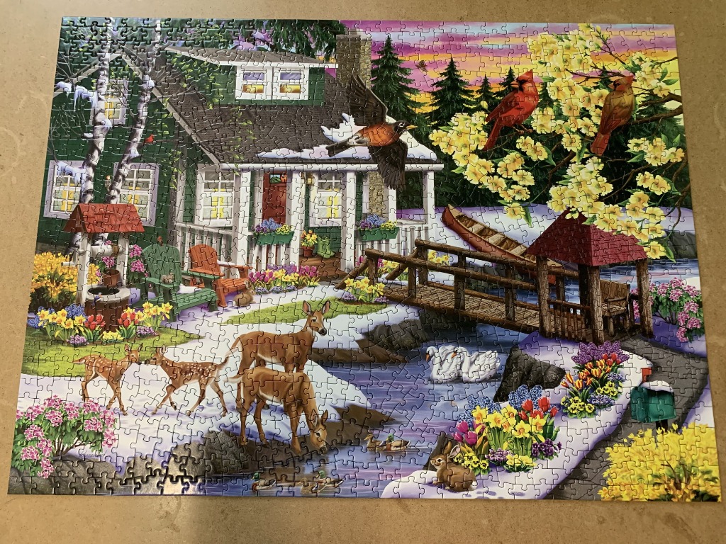 A cozy cabin scene in spring with deer, birds, and flowers