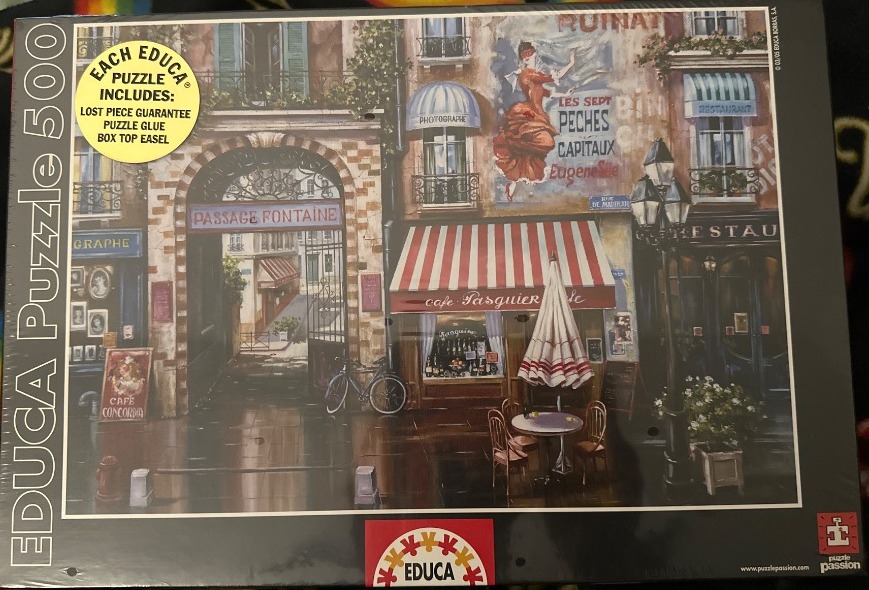 A charming Parisian street scene with an arched stone passage, a red-and-white striped cafe awning, and vintage posters.