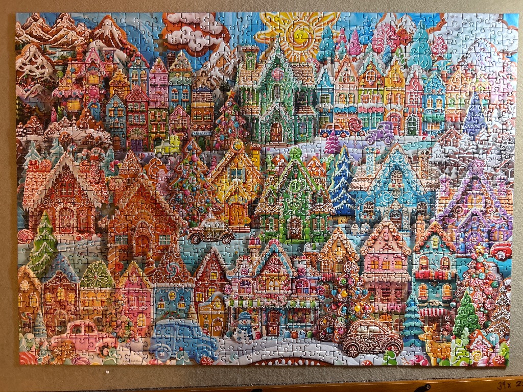 A whimsical candy-themed winter village illustration with gingerbread houses and colorful holiday decorations.