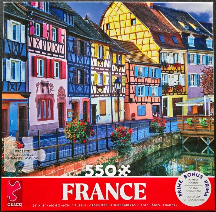 Colorful half-timbered houses lining a canal in a French village