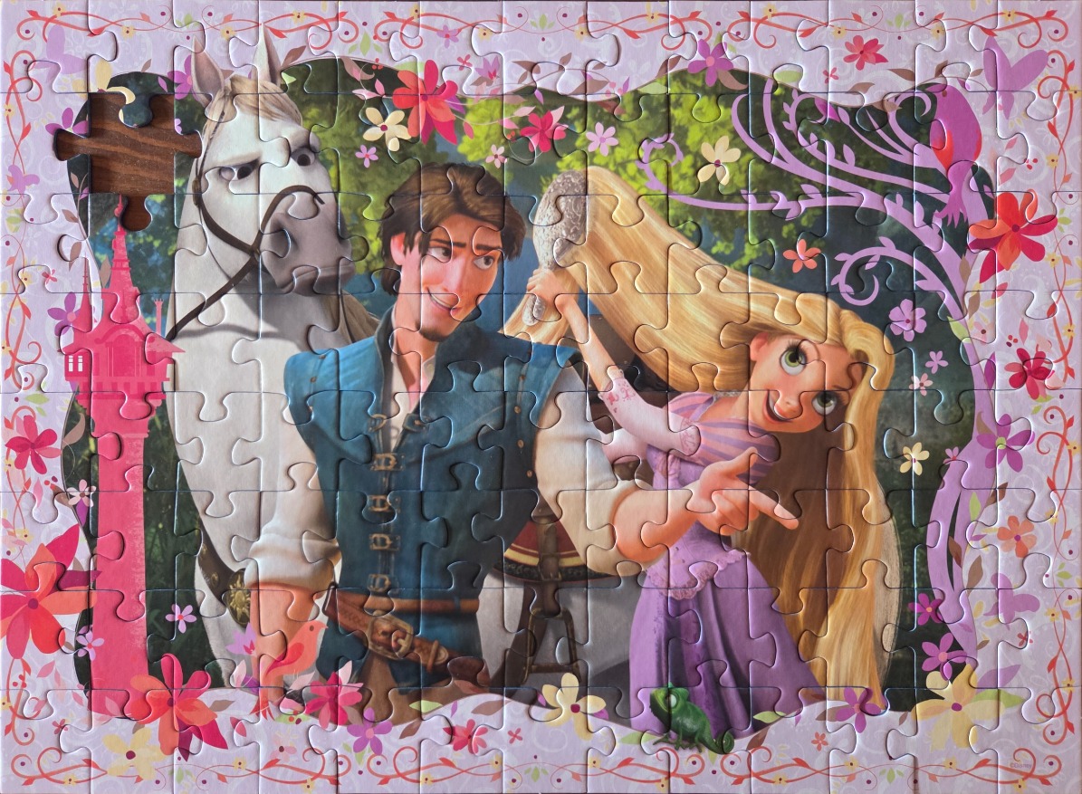 Rapunzel, Flynn Rider, and Maximus from Tangled in a floral-framed cartoon illustration.