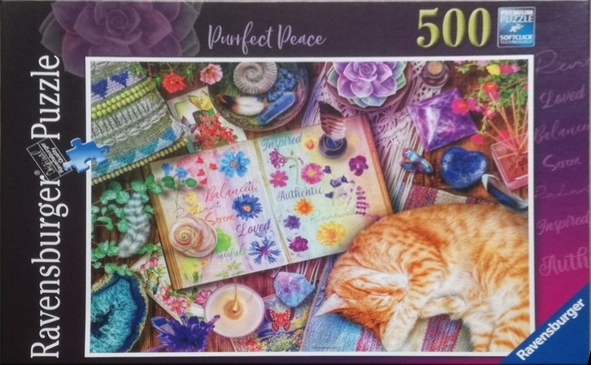 An orange tabby cat sleeping next to an open journal filled with dried flowers and inspiring words on a table with crystals.