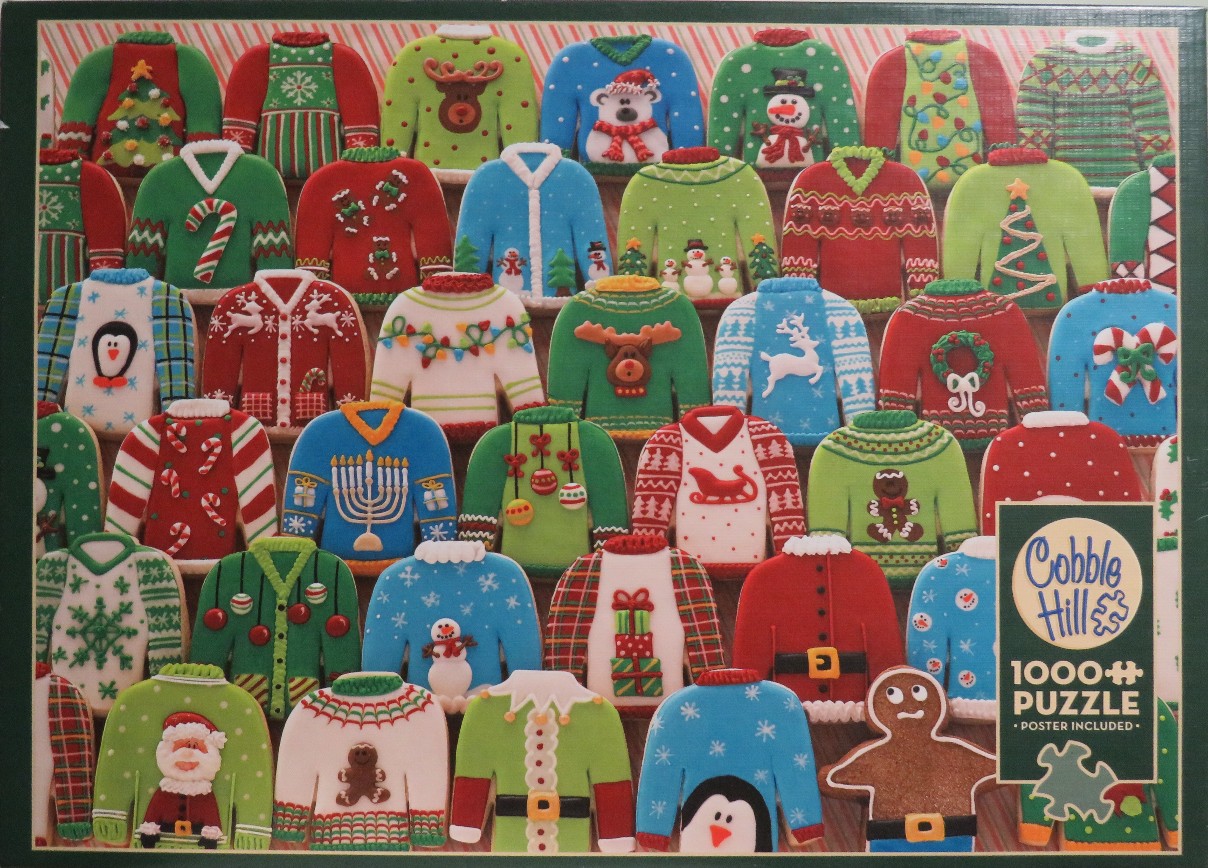 Rows of colorful Christmas sweater-shaped sugar cookies decorated with festive icing designs.