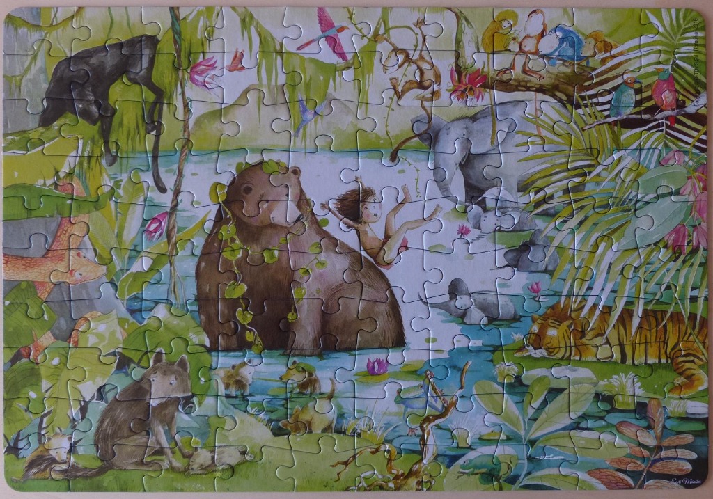 A whimsical illustration of a jungle scene featuring Mowgli, a bear, an elephant, and other animals.