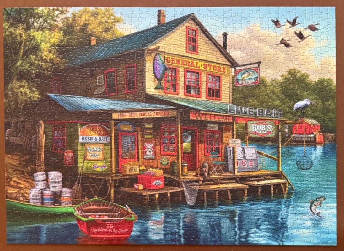 A riverside general store with a boat, ice chest, and fishing signs.