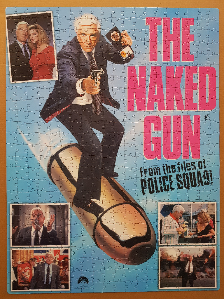 Movie poster imagery for The Naked Gun featuring Leslie Nielsen riding a giant bullet.