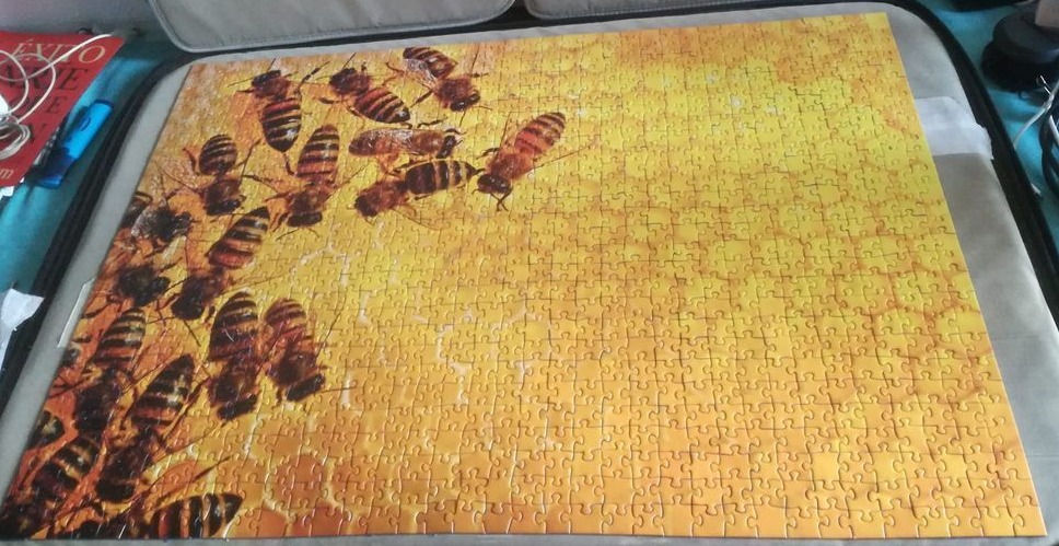 A swarm of bees crawling over a textured, golden honeycomb background.