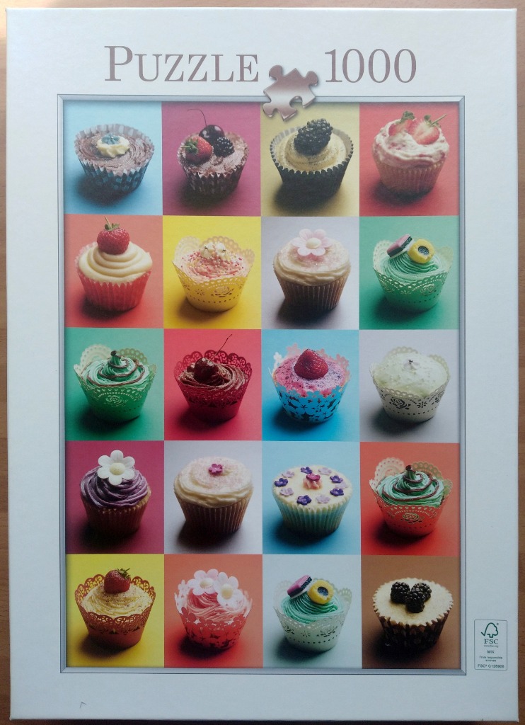 A grid of twenty colorful cupcakes, each in a unique decorative paper liner, arranged against vibrant background colors.