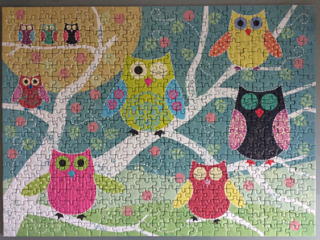 Whimsical illustration of stylized owls perched in white tree branches against a divided background of yellow and teal.