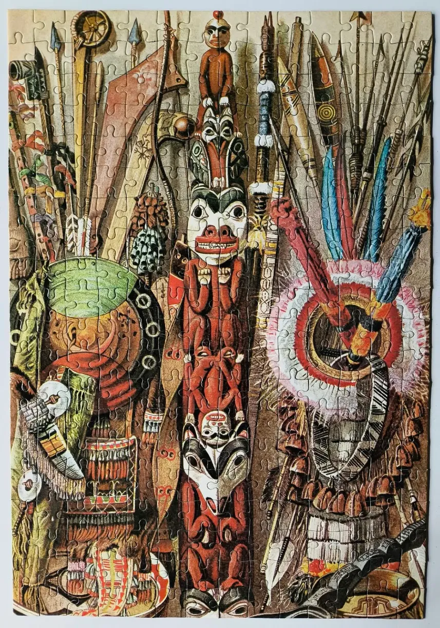 An illustration of a totem pole surrounded by ceremonial tribal weapons, masks, and artifacts.