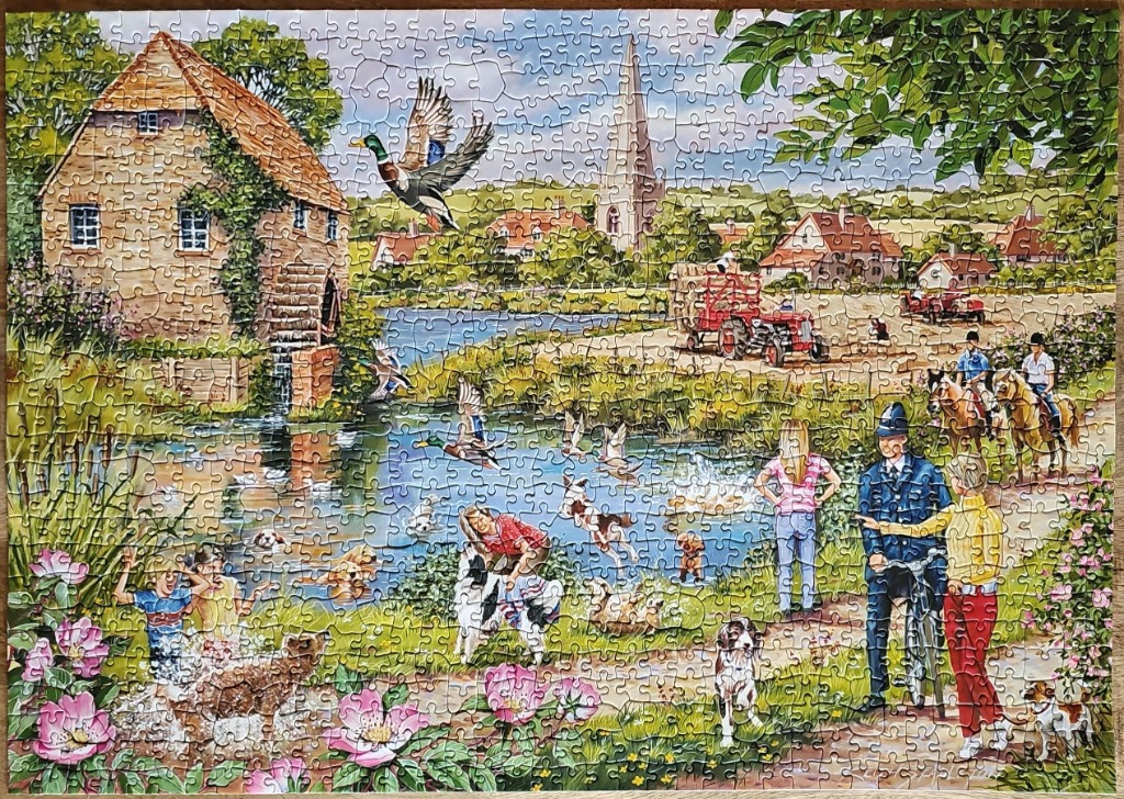 A lively English countryside scene featuring a water mill, a pond with ducks and dogs, and villagers on a summer day.