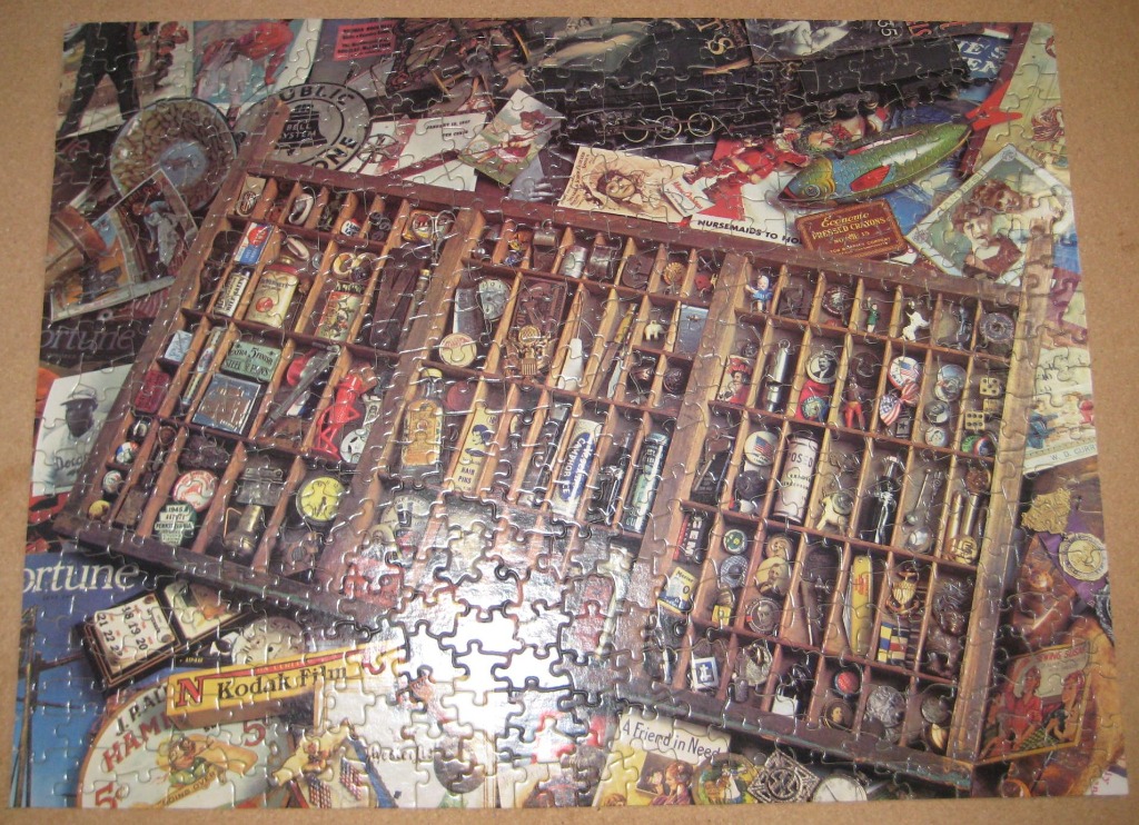 A nostalgic collage featuring a wooden typesetter’s drawer filled with small vintage trinkets and collectibles.