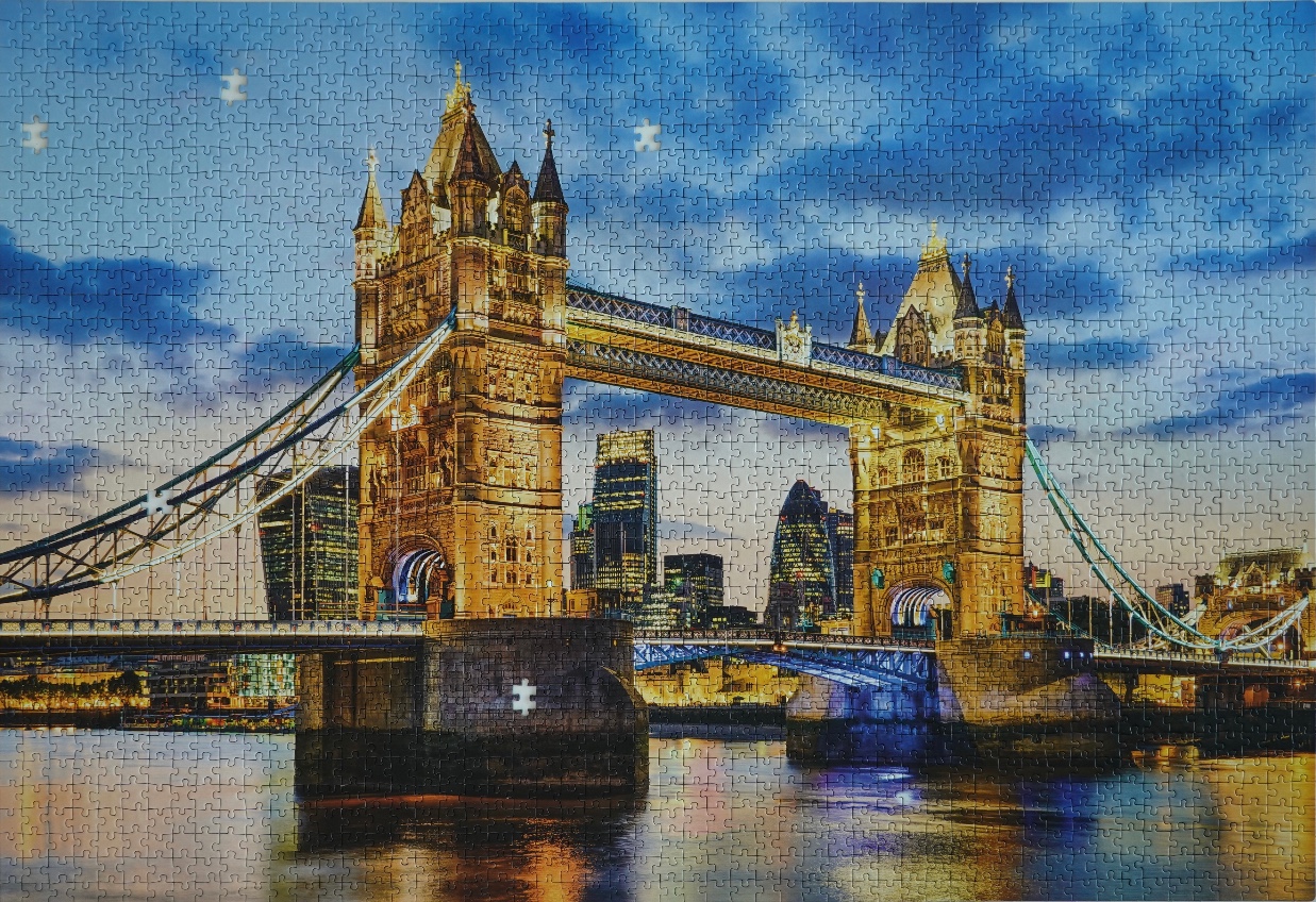 A photograph of Tower Bridge in London at twilight with the city skyline illuminated in the background.