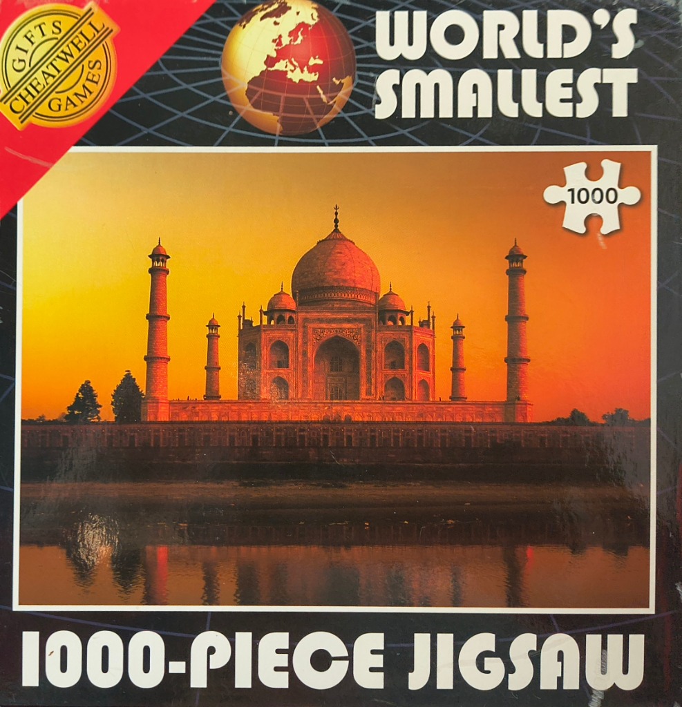 A photograph of the Taj Mahal at sunset, reflected in the water below.