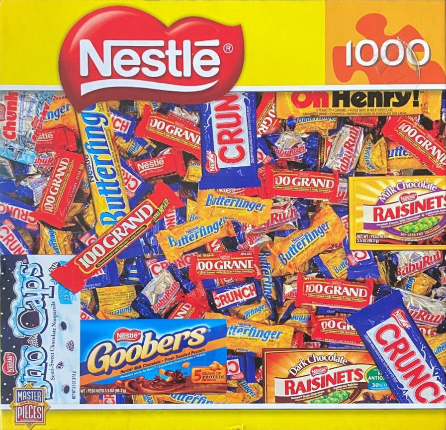 A dense, colorful collage of various chocolate candy bar wrappers.