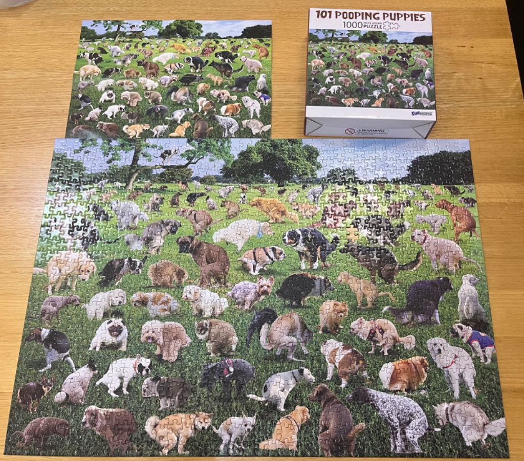 A humorous scene filled with dozens of puppies of various breeds scattered across a large, bright green grassy field.