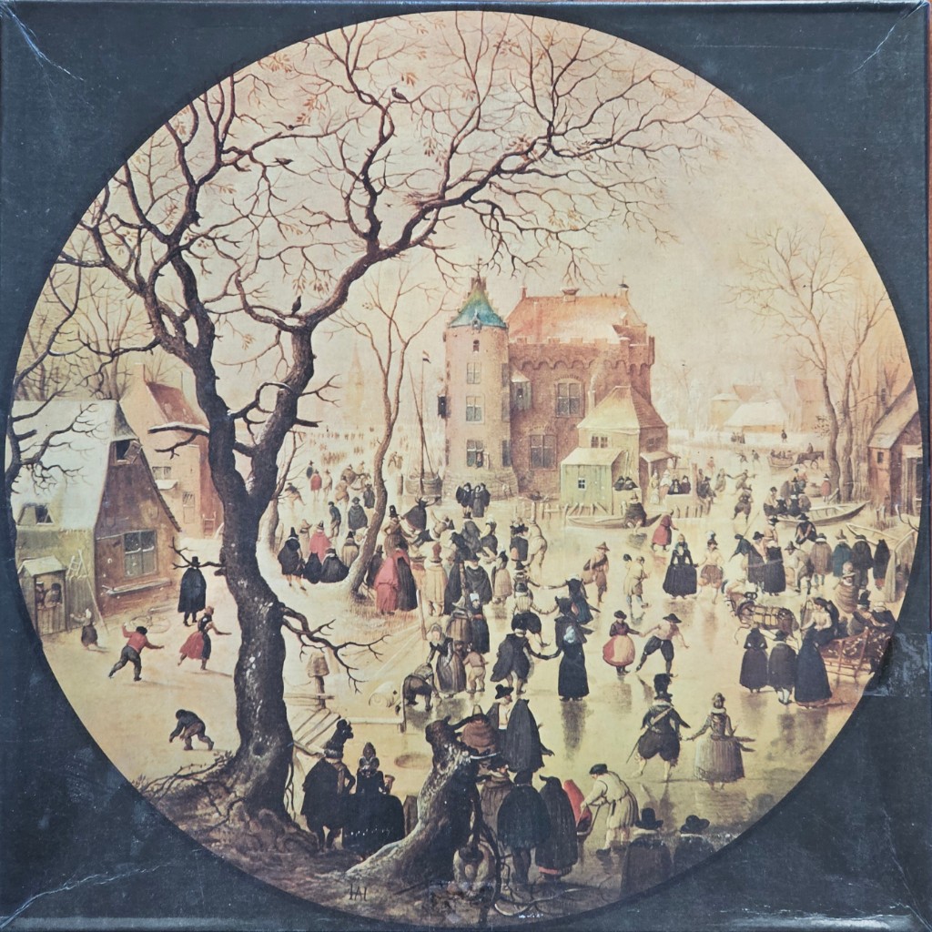 A circular winter landscape painting of people skating on a frozen river in front of a castle.