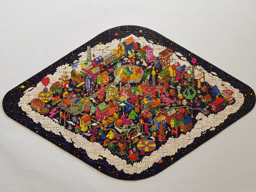 A diamond-shaped illustration of a chaotic, colourful town floating in space.