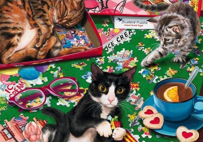 Three cats interacting with a table scattered with jigsaw pieces, glasses, and a cup of tea.