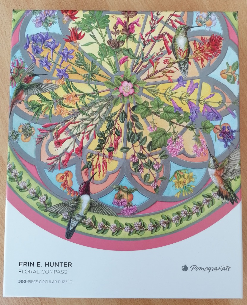 An illustration of three hummingbirds hovering around a circular stained-glass style pattern filled with flowers.