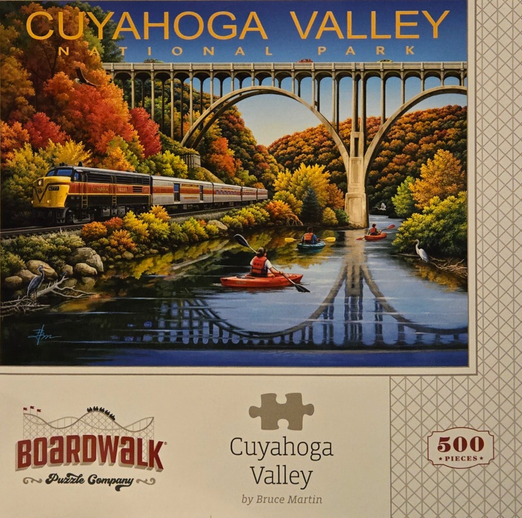 An illustration of the Cuyahoga Valley National Park featuring a train, kayakers, and the Ohio Turnpike bridge in autumn.