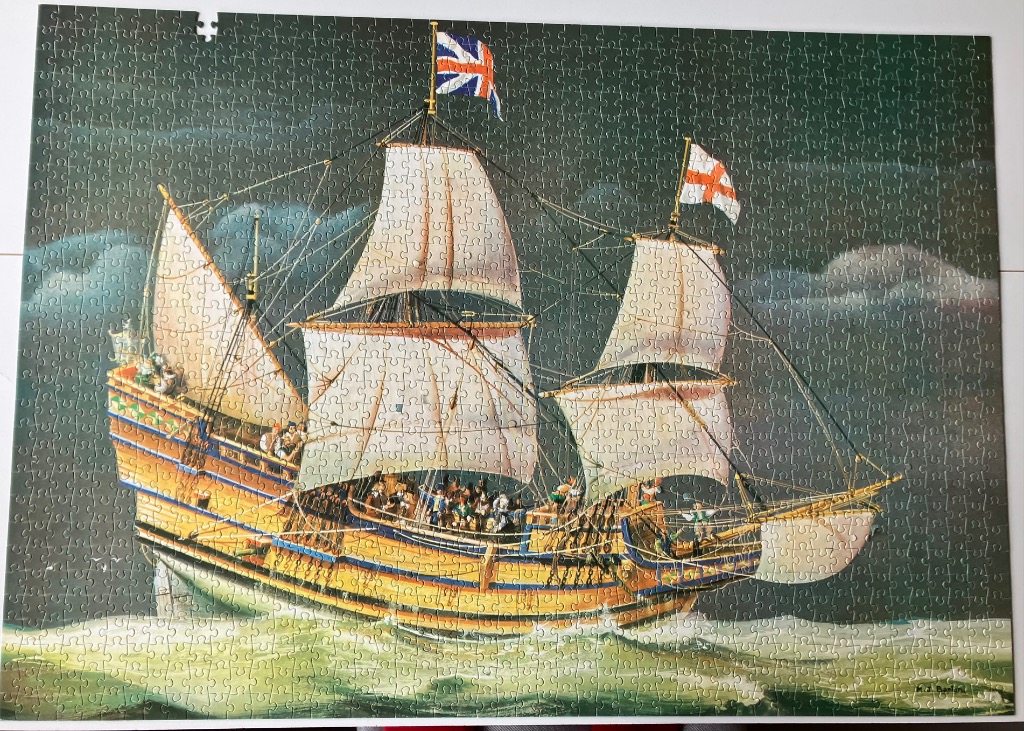 A historical illustration of a multi-masted wooden galleon sailing on a dark, choppy sea.