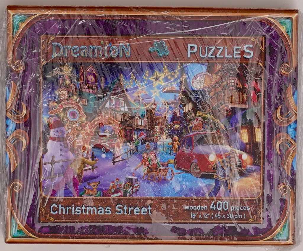 A festive Christmas street scene featuring children, a snowman, and a red car in a snowy village at night.