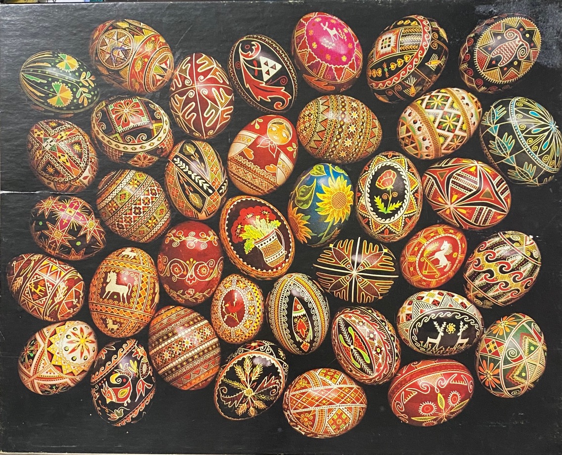 A collection of intricately decorated traditional Easter eggs arranged against a solid black background.