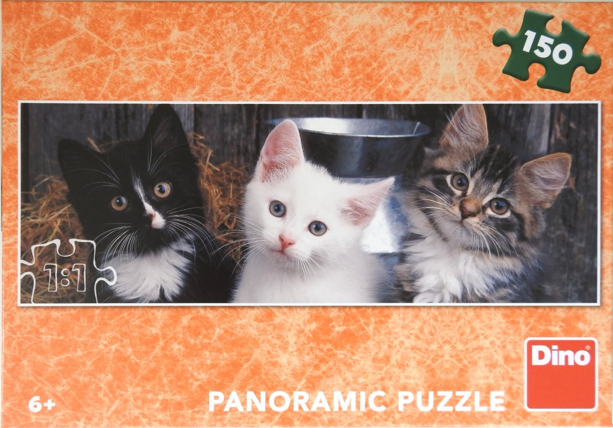 Three kittens sitting side-by-side in front of a rustic wooden background.