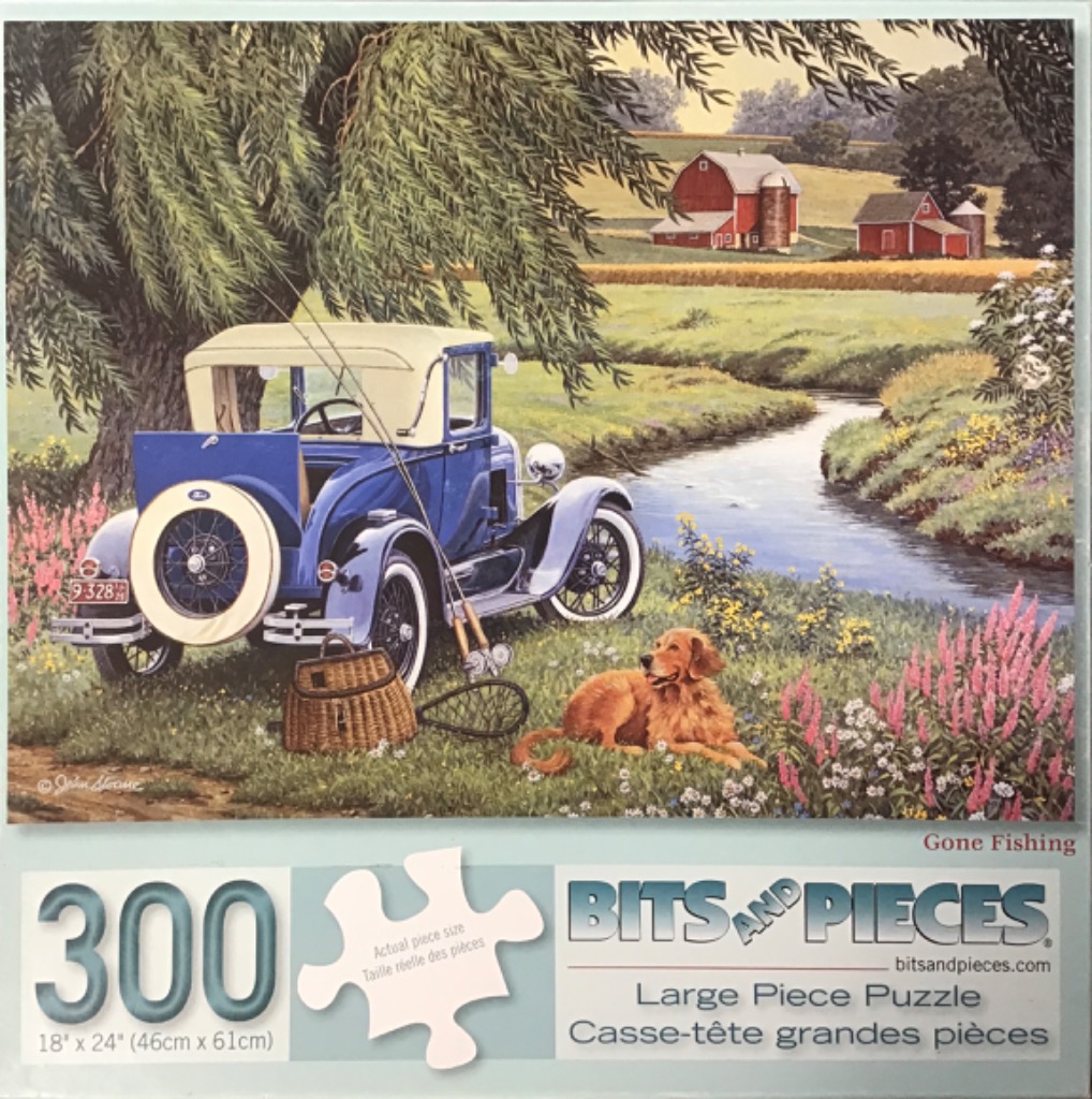 A vintage blue Ford roadster parked by a stream near a willow tree with a golden retriever sitting in the grass.
