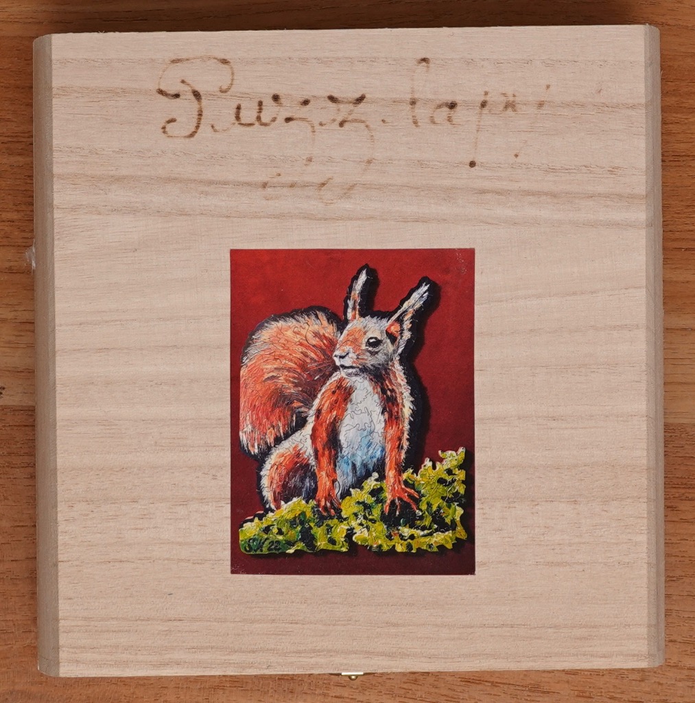 A painted illustration of a red squirrel sitting on green moss against a deep red background.